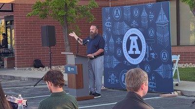 A man stands at a pulpit giving a speech.